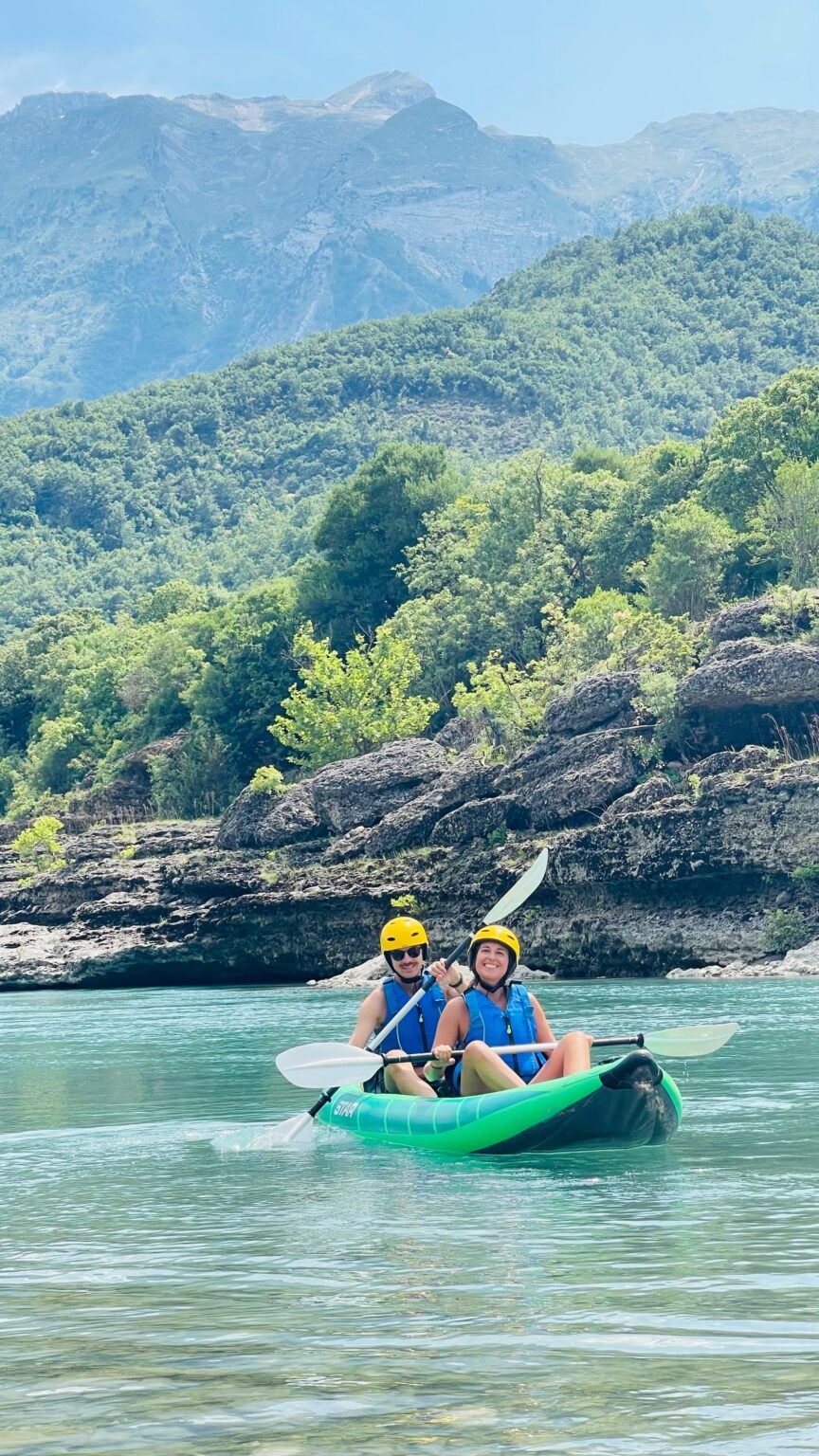 A double kayak paddling through the Vjosa valley near Përmet on a multi-day trip