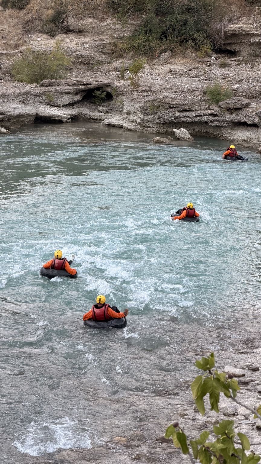 Vjosa River tubing in Përmet, Albania: four guests floating on traditional inner tubes