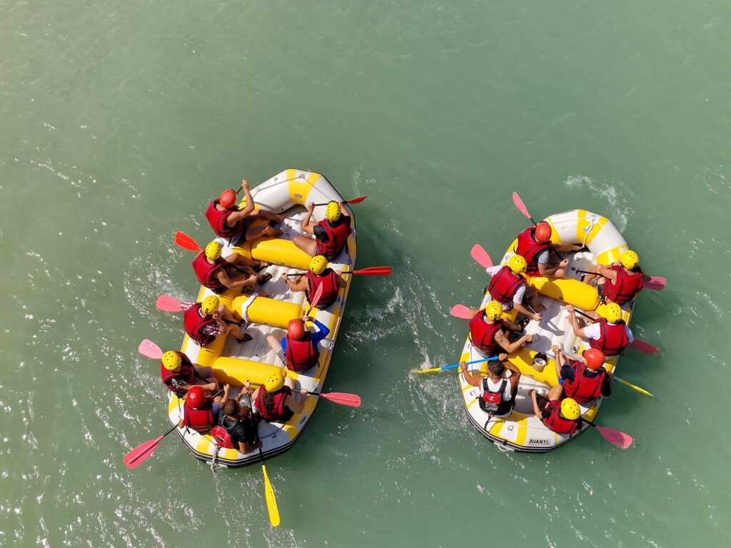 Rafting team paddling together on the Vjosa River near Përmet
